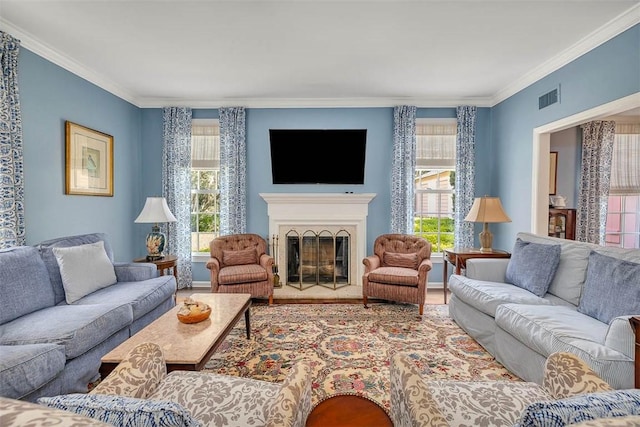 living room featuring hardwood / wood-style floors, a wealth of natural light, and ornamental molding