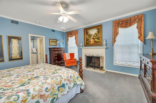 carpeted bedroom with ceiling fan and ornamental molding