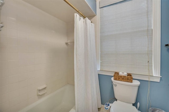 bathroom featuring shower / bathtub combination with curtain and toilet