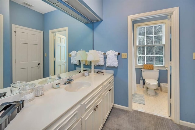 bathroom featuring tile patterned flooring, vanity, and toilet