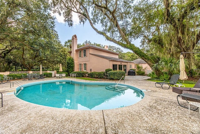 view of swimming pool with a patio area