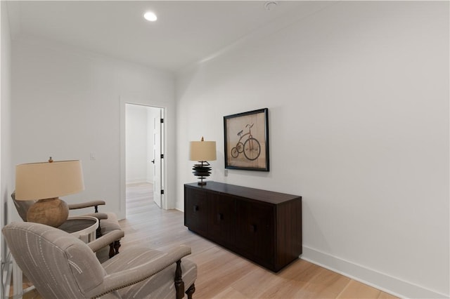 sitting room featuring recessed lighting, baseboards, and light wood finished floors