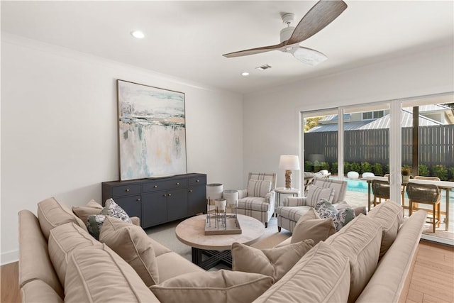living area with recessed lighting, ceiling fan, visible vents, and light wood-style flooring