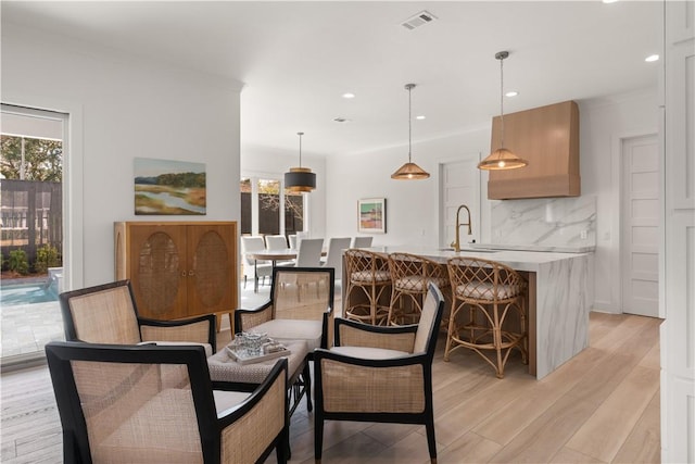 dining room featuring recessed lighting, visible vents, a wealth of natural light, and light wood-style floors