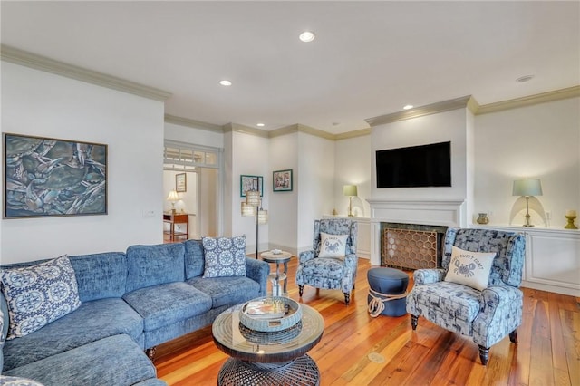 living room with hardwood / wood-style flooring and crown molding