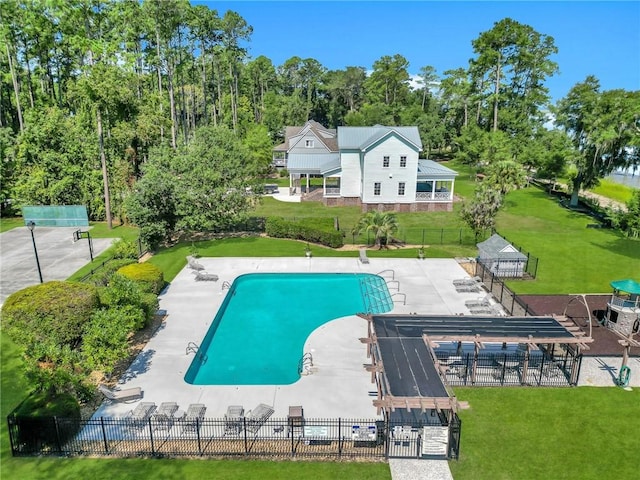 view of pool featuring a pergola, a patio area, and a lawn