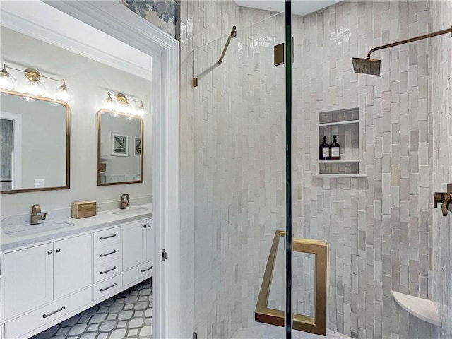 bathroom with ornamental molding, tiled shower, and vanity