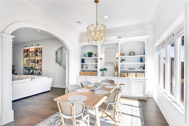 entrance foyer with dark wood-type flooring, ornamental molding, and a chandelier