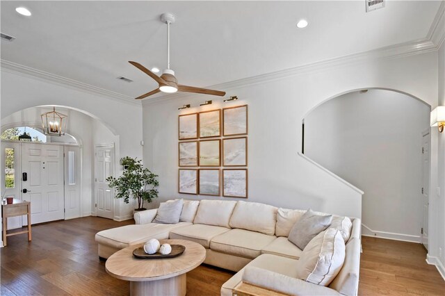 dining area featuring a notable chandelier, crown molding, dark hardwood / wood-style floors, and built in shelves