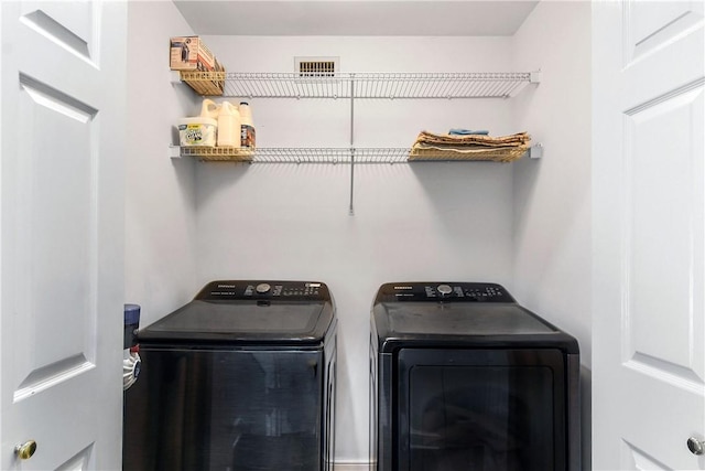 clothes washing area featuring washing machine and dryer