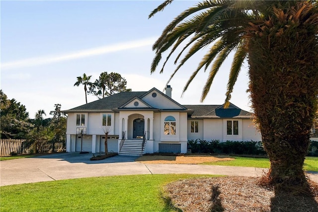 view of front facade with a garage and a front lawn