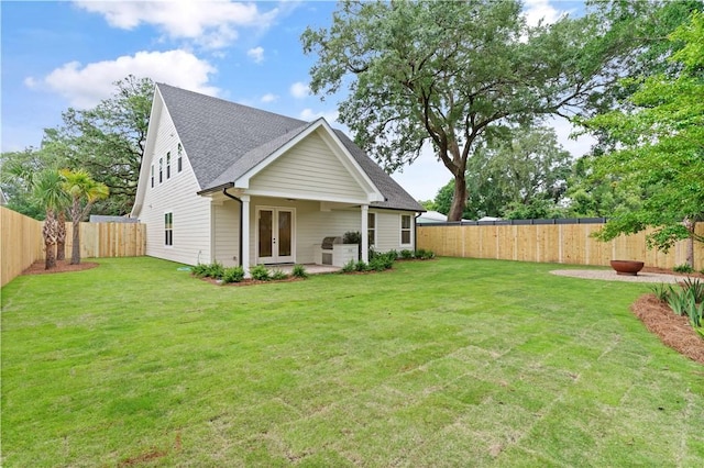 back of property featuring french doors and roof with shingles