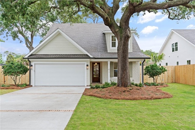view of front of house with roof with shingles, a garage, and driveway