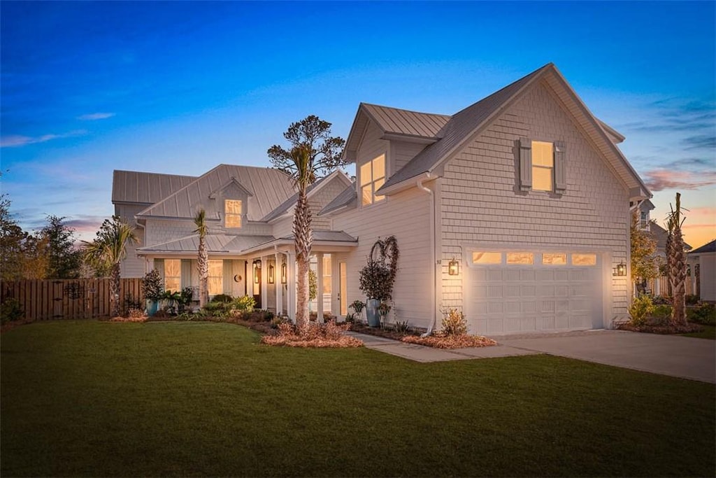 view of property with a garage and a yard