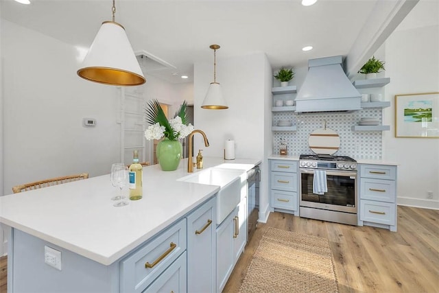 kitchen featuring backsplash, decorative light fixtures, custom range hood, and stainless steel appliances