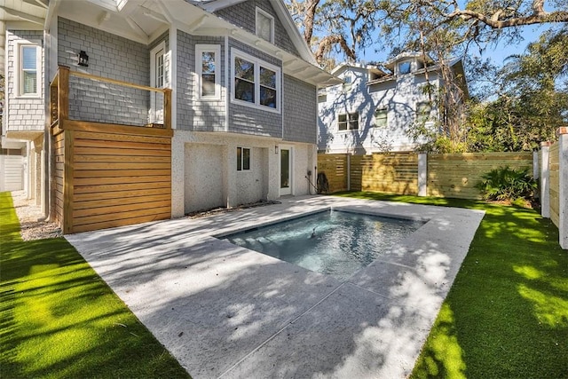 view of pool featuring a yard and a patio