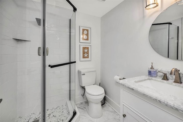 bathroom featuring an enclosed shower, vanity, and toilet