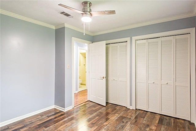 1878 Blalock Ave, Waycross, GA 31503 - unfurnished bedroom with multiple closets, wood finished floors, ornamental molding, baseboards, and a ceiling fan