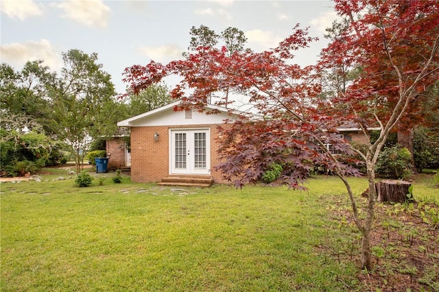 1878 Blalock Ave, Waycross, GA 31503 - rear view of property featuring french doors, a lawn, brick siding, and entry steps