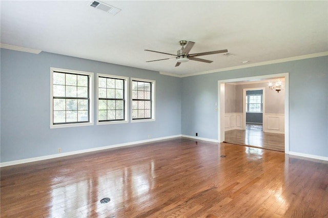 1878 Blalock Ave, Waycross, GA 31503 - empty room featuring a chandelier, wood finished floors, a ceiling fan, ornamental molding, and baseboards