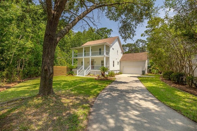 134 Newfield St, Saint Simons Island, GA 31522 - view of front of house with a balcony, a porch, a garage, and roof with shingles