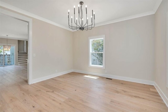 134 Newfield St, Saint Simons Island, GA 31522 - spare room with a chandelier, light wood-style floors, stairs, and crown molding