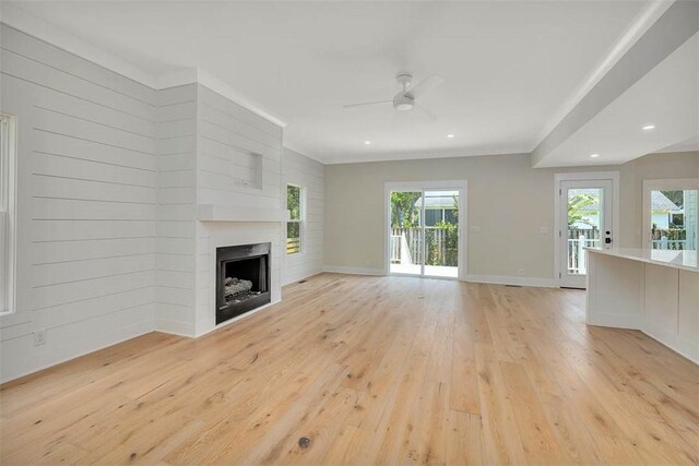 134 Newfield St, Saint Simons Island, GA 31522 - unfurnished living room featuring light wood-style floors, ceiling fan, a fireplace, recessed lighting, and crown molding