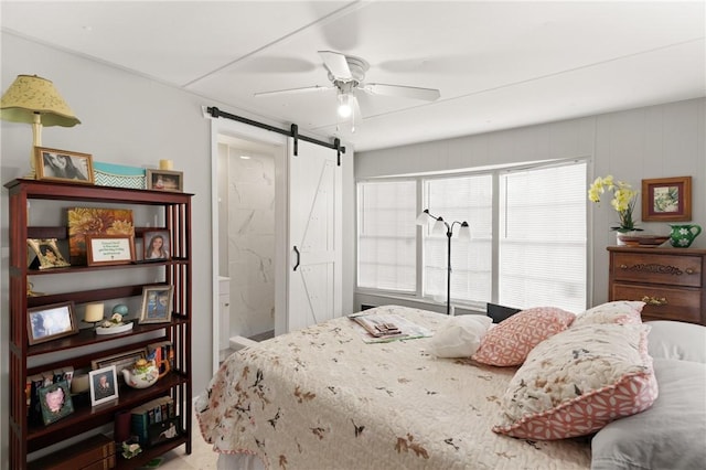 2388 Waycross Hwy, Jesup, GA 31545 - bedroom featuring a barn door, a ceiling fan, and ensuite bath