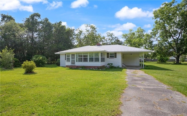 2388 Waycross Hwy, Jesup, GA 31545 - view of front of home featuring asphalt driveway, a front lawn, a carport, and a metal roof