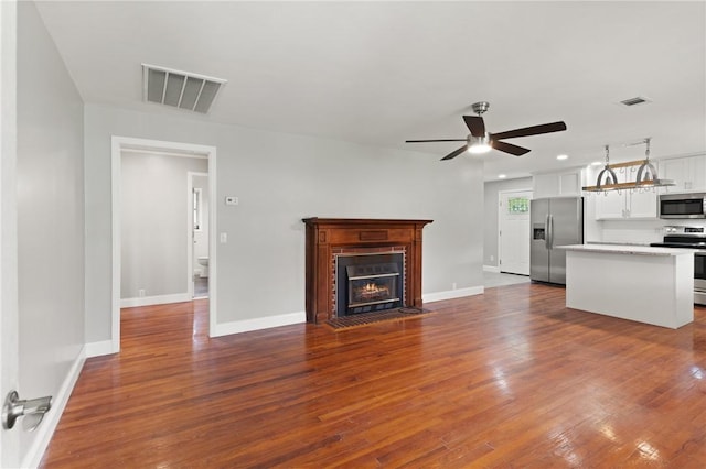2388 Waycross Hwy, Jesup, GA 31545 - unfurnished living room featuring a ceiling fan, dark wood-type flooring, and a fireplace with flush hearth