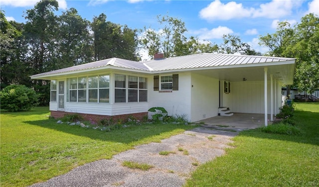 2388 Waycross Hwy, Jesup, GA 31545 - view of front of property featuring driveway, a front lawn, a carport, and a metal roof