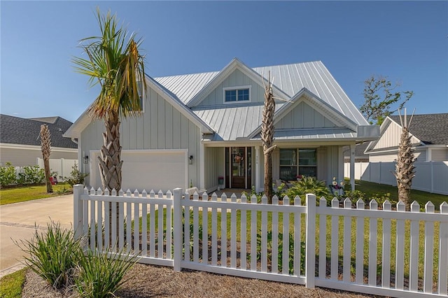 506 Conservation Dr, Saint Simons Island, GA 31522 - view of front facade featuring a garage, driveway, metal roof, board and batten siding, and covered porch