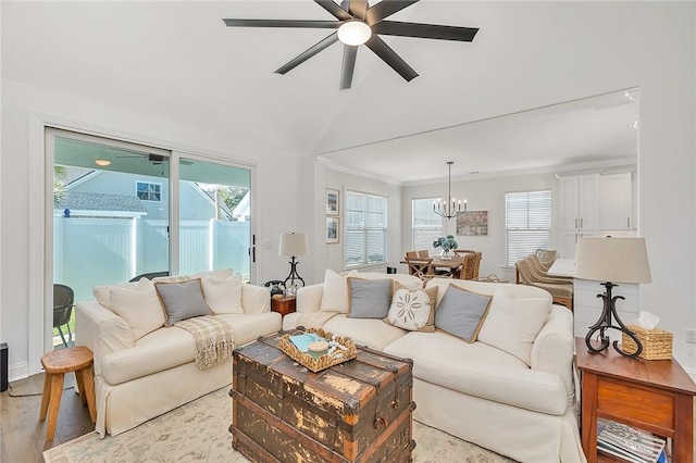 506 Conservation Dr, Saint Simons Island, GA 31522 - living room with light wood-style flooring, a ceiling fan, a chandelier, and vaulted ceiling