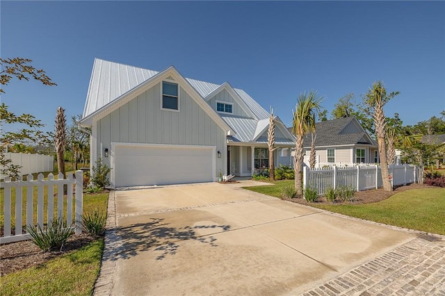 506 Conservation Dr, Saint Simons Island, GA 31522 - view of front facade with board and batten siding, concrete driveway, a garage, and metal roof