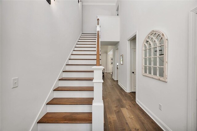 506 Conservation Dr, Saint Simons Island, GA 31522 - staircase featuring a high ceiling, wood finished floors, baseboards, and crown molding