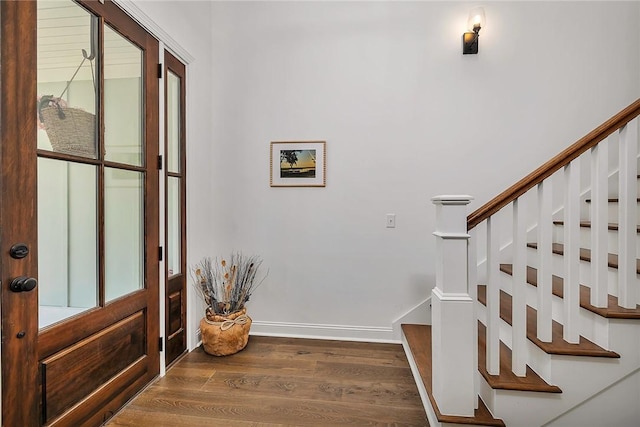 506 Conservation Dr, Saint Simons Island, GA 31522 - entrance foyer with wood finished floors, stairway, and baseboards