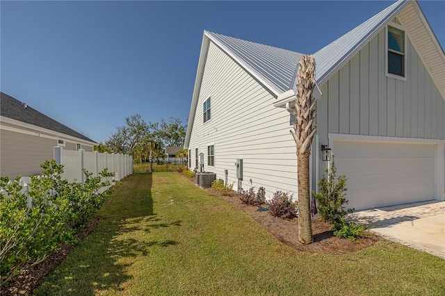 506 Conservation Dr, Saint Simons Island, GA 31522 - view of property exterior featuring board and batten siding, a garage, concrete driveway, central air condition unit, and metal roof