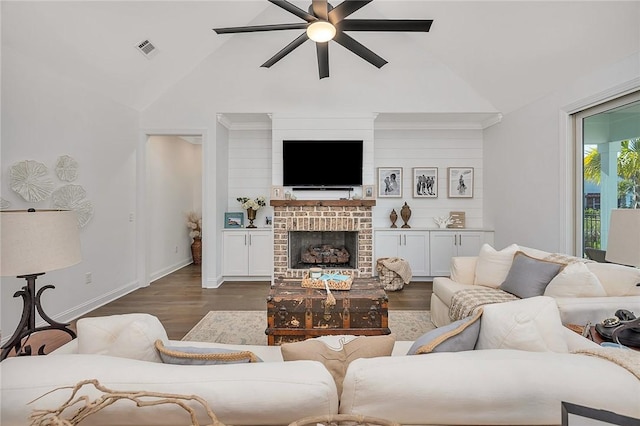 506 Conservation Dr, Saint Simons Island, GA 31522 - living area with a ceiling fan, dark wood finished floors, a brick fireplace, high vaulted ceiling, and baseboards