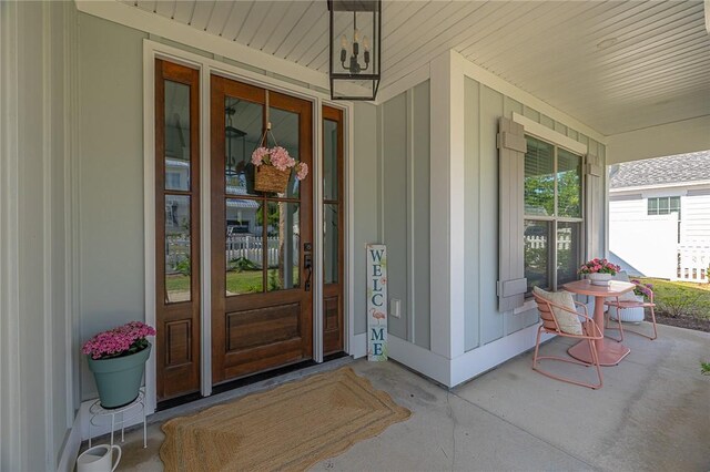 506 Conservation Dr, Saint Simons Island, GA 31522 - view of exterior entry featuring covered porch and board and batten siding