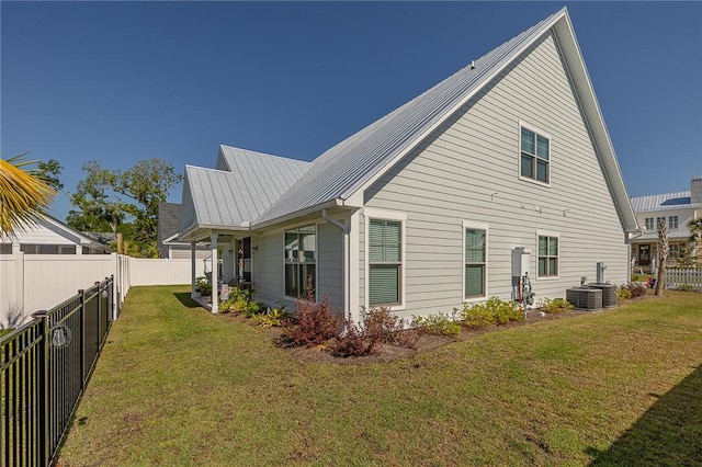506 Conservation Dr, Saint Simons Island, GA 31522 - rear view of house featuring metal roof and central AC