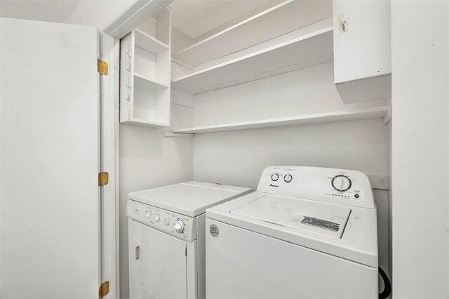 clothes washing area featuring washer and dryer