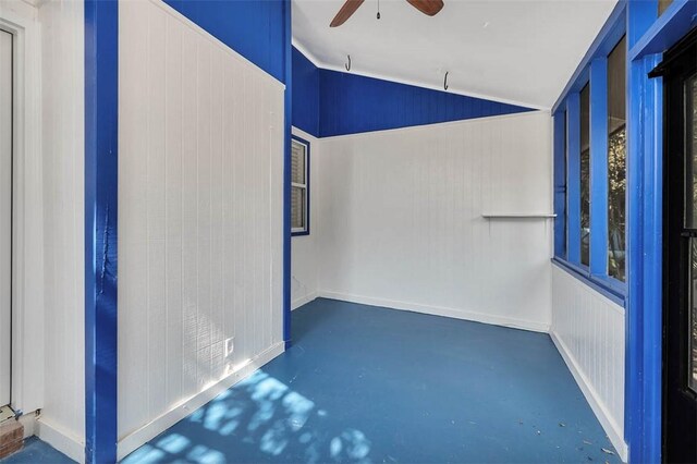 empty room featuring concrete floors, ceiling fan, and lofted ceiling