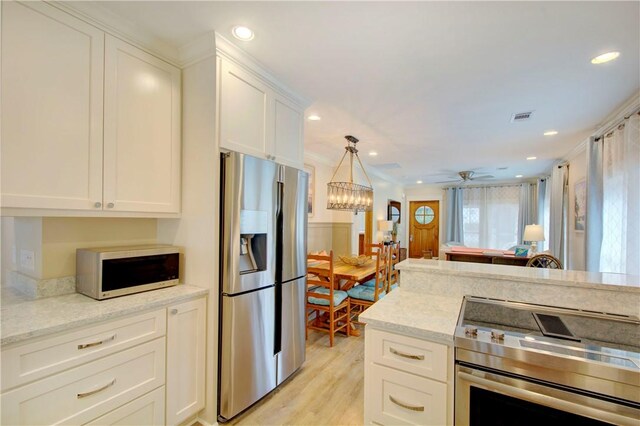 kitchen with white cabinetry, ceiling fan, stainless steel appliances, and light stone counters