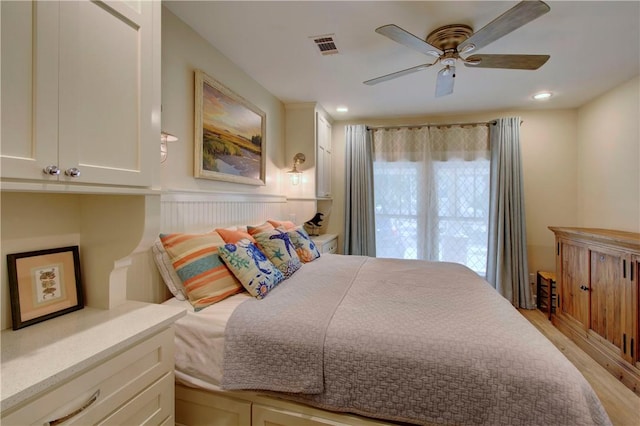 bedroom with ceiling fan and light hardwood / wood-style floors