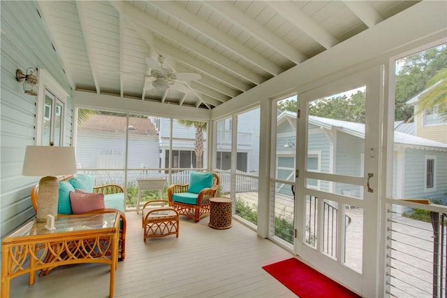 sunroom with vaulted ceiling with beams, ceiling fan, and wood ceiling