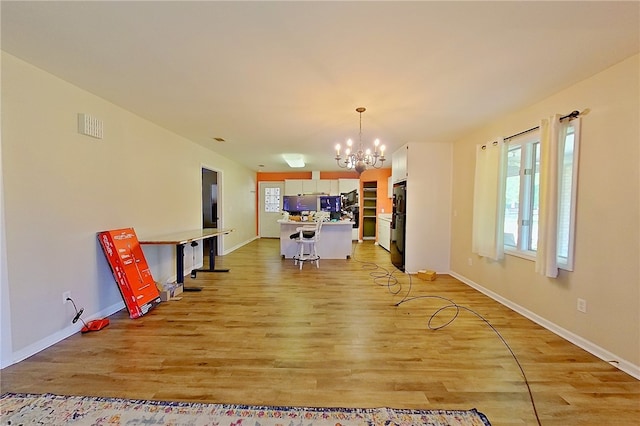 2204 Gibbs St, Waycross, GA 31503 - unfurnished living room with a chandelier and light wood-type flooring