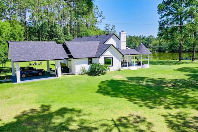 2204 Gibbs St, Waycross, GA 31503 - back of property with a chimney, a shingled roof, a yard, a carport, and stucco siding