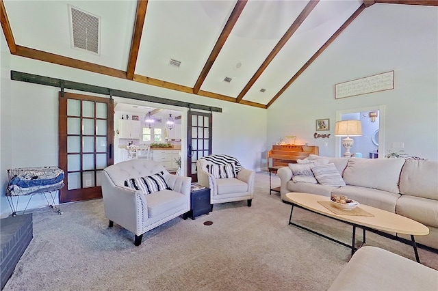 2204 Gibbs St, Waycross, GA 31503 - carpeted living room with high vaulted ceiling, beam ceiling, and a barn door