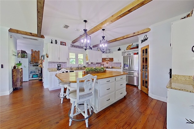 2204 Gibbs St, Waycross, GA 31503 - kitchen featuring stainless steel fridge, wooden counters, open shelves, beam ceiling, and backsplash