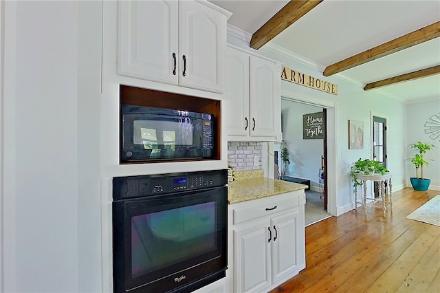 2204 Gibbs St, Waycross, GA 31503 - kitchen with black appliances, beamed ceiling, white cabinetry, light stone counters, and light wood-style floors